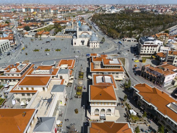 Bird's eye view of town square and surrounding buildings with characteristic red roofs, aerial