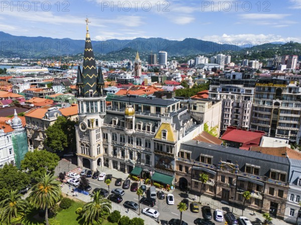 City view with impressive, historically inspired buildings in front of a mountain panorama, aerial