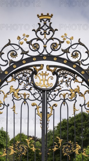 Magnificently decorated iron gate with golden ornaments and crown, Kensington, London, England,