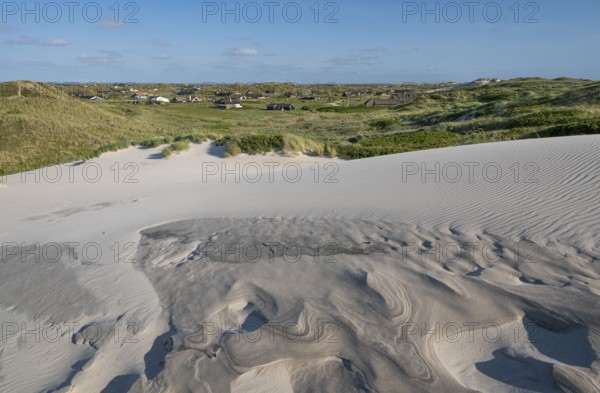 Dunes with beach grass, wave pattern in the sand, holiday settlement, blue sky, Hvide Sande, North