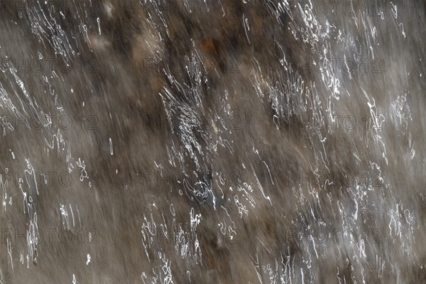 Close-up of moving water with a pattern of light and shadow, light trails, long exposure, North