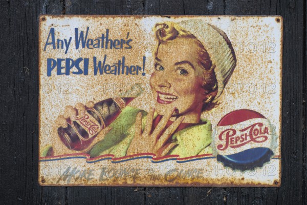 Retro Pepsi advertising sign with smiling woman and nostalgic design, Ringkøbing, Ringkøbing Fjord,