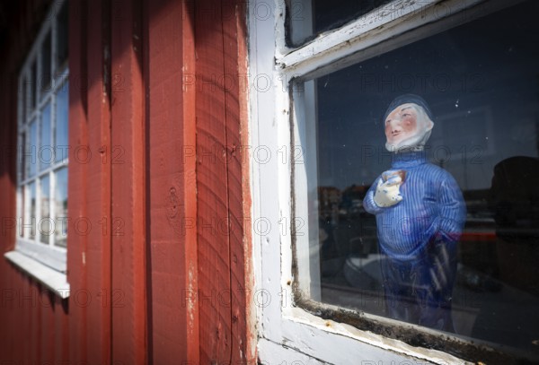 Sailor doll standing behind the window of a red wooden house, harbour, Ringkøbing, Ringkøbing