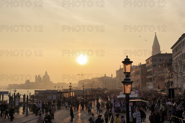 Crowd, Boat dock at St Mark's Square, St Mark's Basilica, Church on the horizon, Sunset in winter,