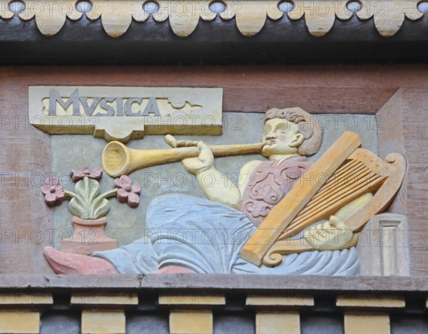 Allegorical woodcarving with figure for music with hand harp, flute and trumpet, lyre, lyre,
