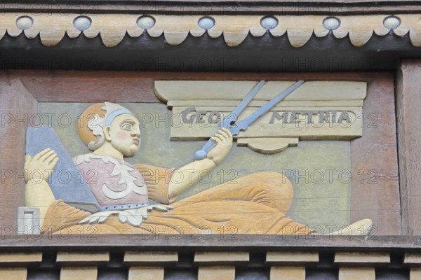 Allegorical woodcarving with figure for geometry with compass, geometric, measured, measurement,