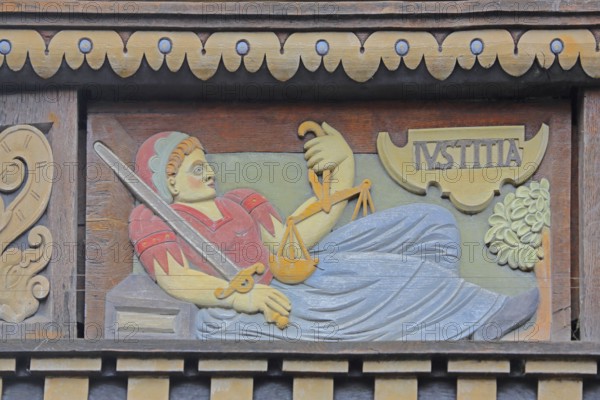 Allegorical woodcarving with figure of Justitia with beam balance and sword, justice, law,
