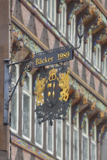 Nose plate with golden year 1989 on the brick house, half-timbered house, window, wrought ironwork,