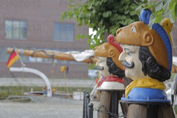 Colourful Swedish heads as landmarks, historical wooden head with face and four eyes, Swedish head