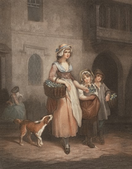 Young woman selling flowers with a dog and two children, selling flowering primroses from a basket,
