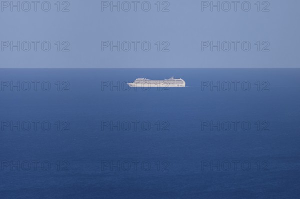 A cruise ship passes near the Costa Rei on the Mediterranean Sea near Sardinia, Monte Nai, Costa