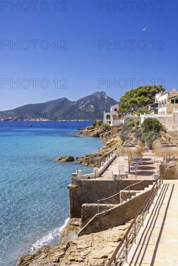 House on the seashore of the blue Mediterranean Sea on a sunny summer day, Sant elm, Mallorca,