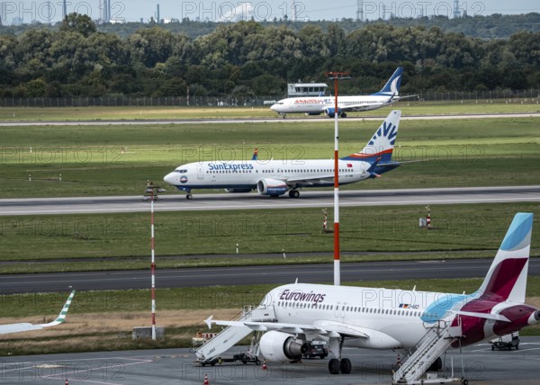Düsseldorf Airport, Eurowings Airbus aircraft on the apron, SunExpress Boeing 737 on take-off,