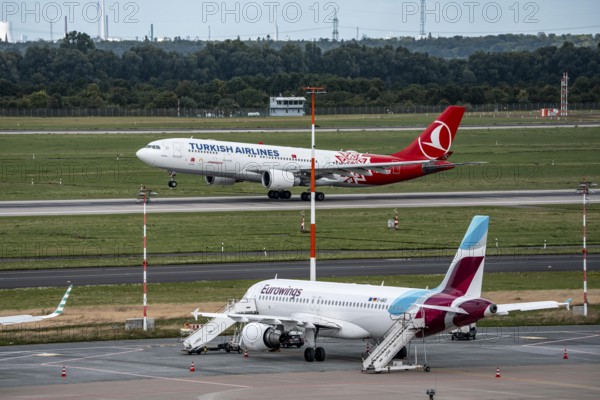 Düsseldorf Airport, Eurowings Airbus aircraft on the apron, Turkish Airlines Airbus A330-200 taking