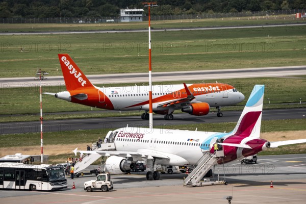 Düsseldorf Airport, Eurowings Airbus aircraft on the apron, EasyJet Airbus A320-200 taxiing for