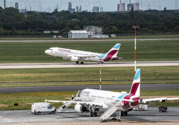 Düsseldorf Airport, Eurowings aircraft taking off, Eurowings Airbus on the apron, skyline of the