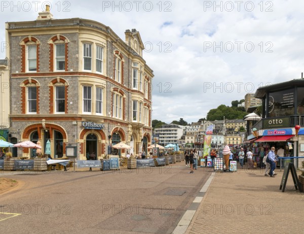 Offshore bar and restaurant, people walking near quayside shops, Vaughan Parade, Torquay, Devon,