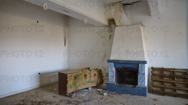 Lost Place, Apitiki, Military post, An empty room with a fireplace and neglected furniture, Photos