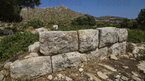 Monumental stone blocks form a wall in a mountainous, naturally beautiful setting, Artemis Temple,