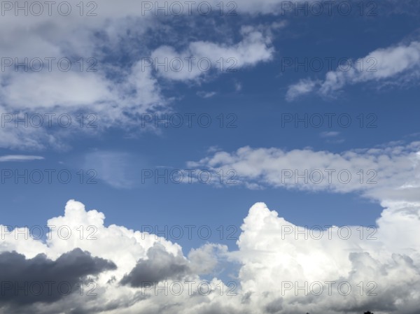 Below grey white stratocumulus clouds, middle above stratocumulus above altostratus in front of