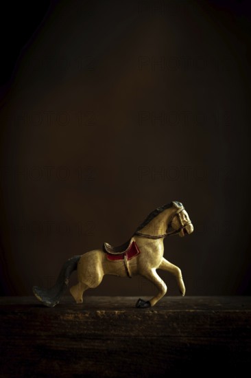 A vintage toy horse appears to be in motion, showcasing intricate details and a nostalgic design.