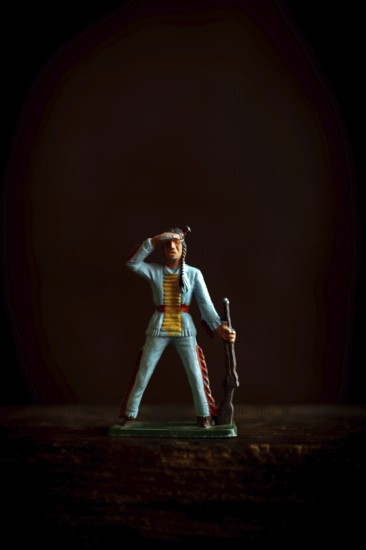 Intricate Native American Indian figure toy figurine in a blue uniform confidently salutes while