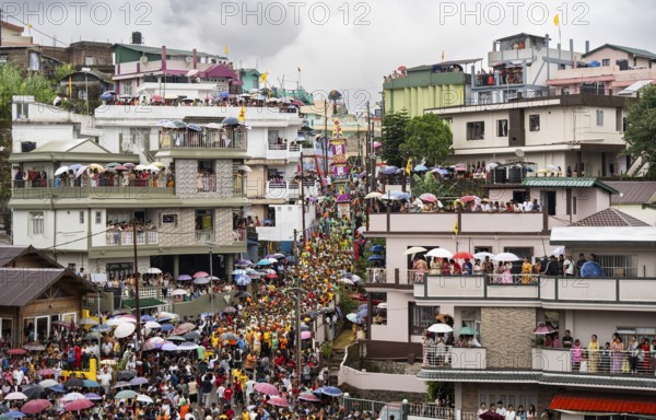 People from the Pnar community emjoy the Behdienkhlam festival from rooftop in Jowai, India on July