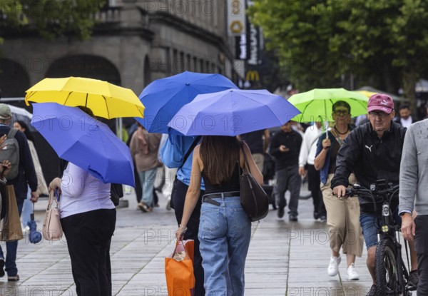 Rainy weather in Stuttgart. People with umbrellas hurry through the rain on Königstraße. Stuttgart,