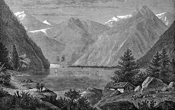 Lake Königsee, idyllic mountain landscape, snow-covered mountains, fir trees, sailing boats,
