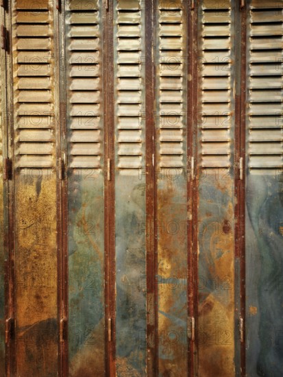 Rustic wooden shutters exhibit a blend of rusty and faded paint, showcasing years of weathering in