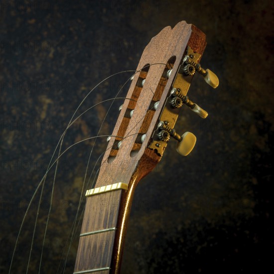 A classical guitar is positioned prominently, showcasing its intricate wooden design and broken
