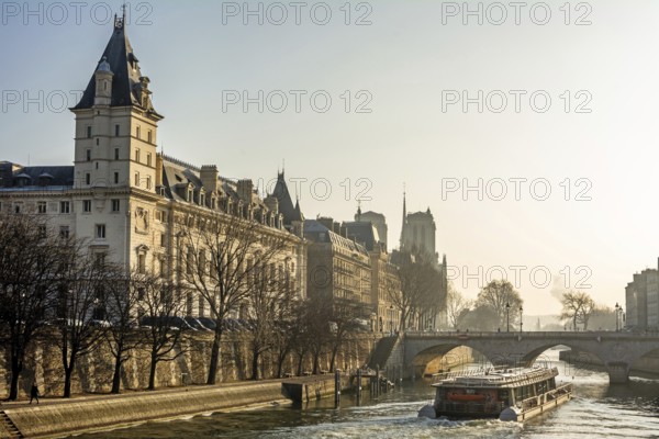 A tour boat navigates the flowing waters of the River Seine, revealing the stunning architecture of