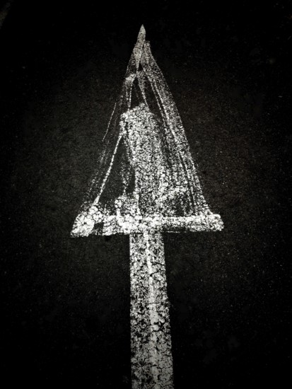 A creative chalk drawing on a dark background depicts a triangular shape with a textured surface
