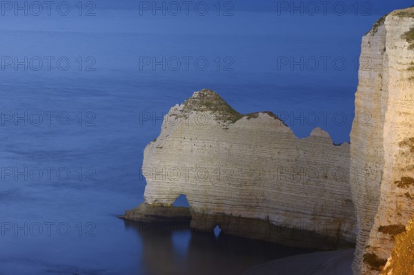 Cliffs with the Porte d'Amont rock gate at dusk, Etretat, Alabaster Coast, Seine-Maritime,