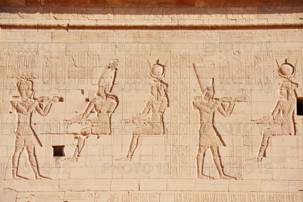 Relief of the king in front of the gods Osiris-Onophris and Isis and the king in front of the gods