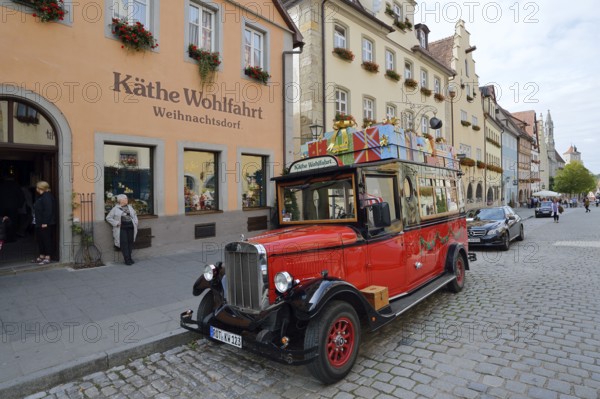 Käthe Wohlfahrt Christmas Village shop, in front of it a vintage car on the street, Rothenburg ob