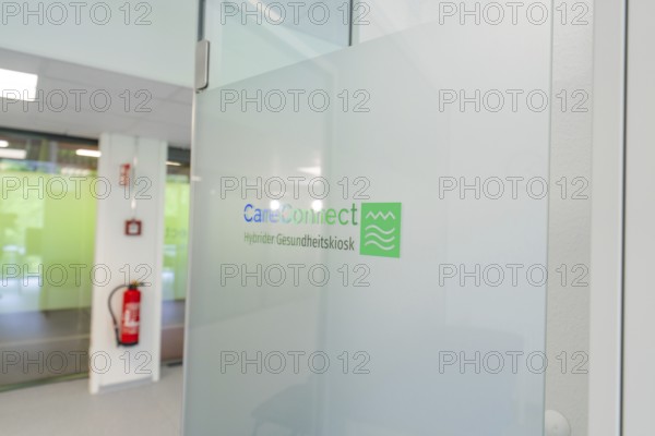 Glass wall with CareConnect logo in a modern office environment, Care Connect, vaccination kiosk