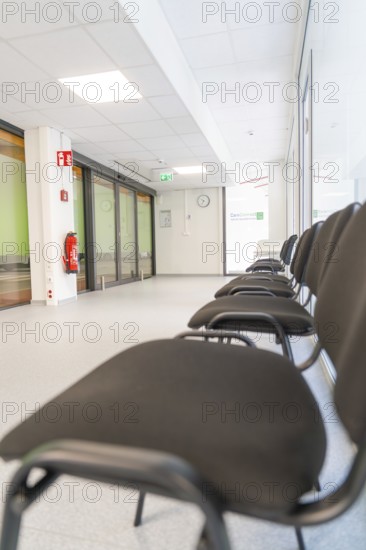 Bright hallway with minimalist chairs in the waiting area, Care Connect, vaccination kiosk for