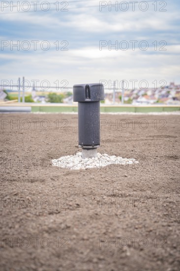 Single ventilation shaft on a green roof with city in the background, green roof, house