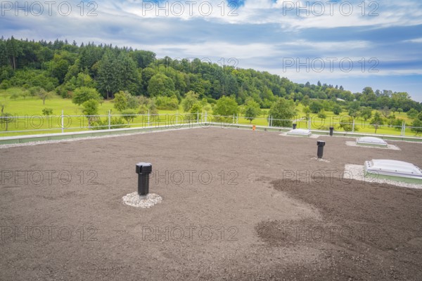 Green roof with several ventilation shafts and cloudy sky, roof greening, house construction,