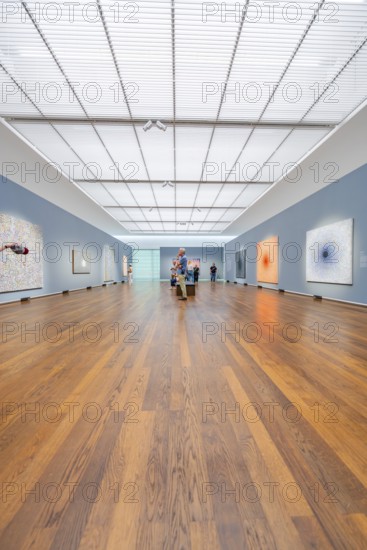 Large, illuminated gallery space with several visitors and works of art on the walls, Frieder Burda