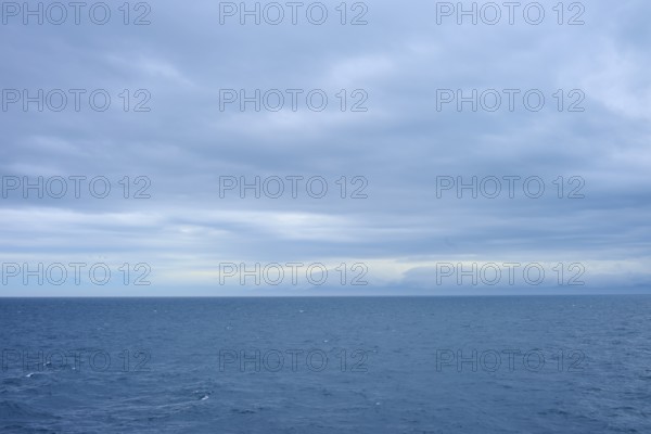 Vast sea under a cloudy sky with a view of distant horizons, summer, Cook Strait, North Island,