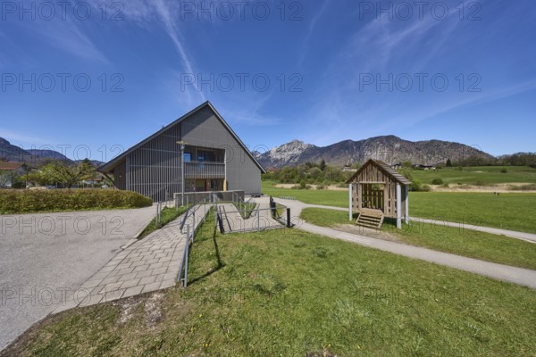 Catholic kindergarten St.Bruder Klaus, building, ramp, metal railing, meadows, mountain landscape,