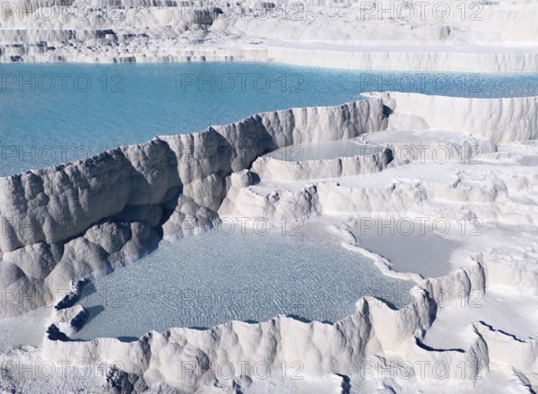 Natural limestone formations with turquoise-coloured water in several cascades. Structure appears