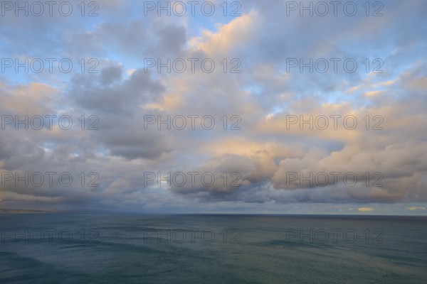 View of the sea under a sky with soft pastel colours at sunset, summer, Nugget Point Lighthouse,