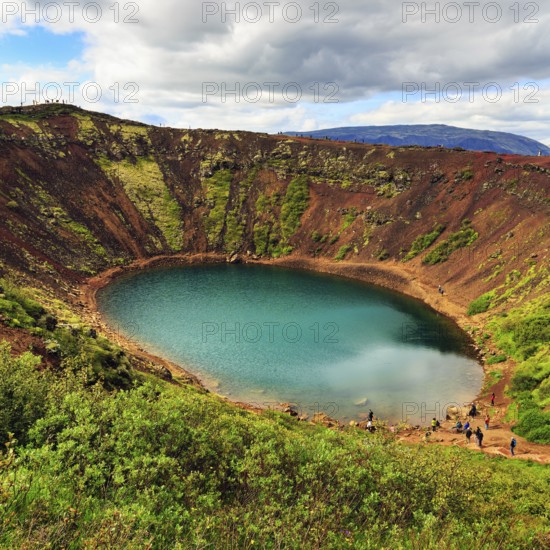 Hikers round Kerið, Kerid, crater lake with turquoise-green water, Golden Circle, ring road,