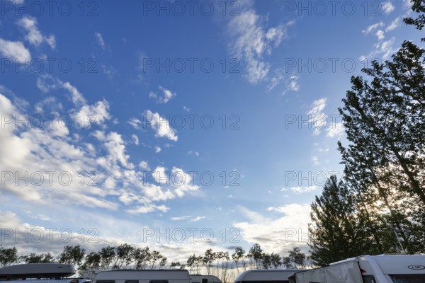 Cumulus, roofs of caravans and motorhomes on a campsite in the evening, Suðurland, Sudurland,