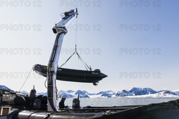 Zodiac on the hook of a ship, sea, Smeerenburg, Spitsbergen, Svalbard