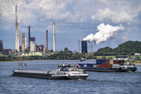 Industrial backdrop of the ThyssenKrupp Steel steelworks in Duisburg-Bruckhausen, cargo ships on