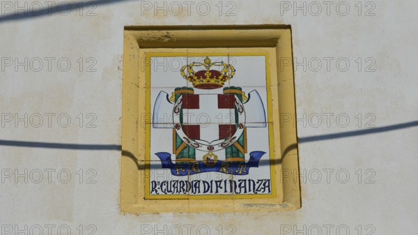 Guardia di Finanza, Coat of arms with crown and shield on beige background, textual elements,